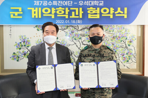 남천현 우석대 총장과 편무삼 제7공수특전여단장이 군 계약학과 협약식에서 협약서를 들어보이고 있다. 사진=우석대 제공