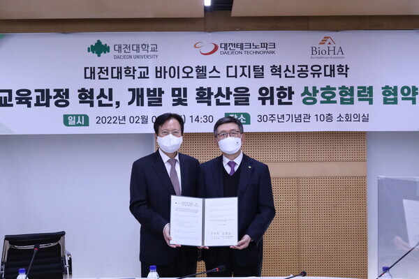 맹필재(왼쪽) 바이오헬스케어협회장과 윤여표 대전대 총장이 상호협력 협약을 체결하고 협약서를 펼쳐보이고 있다. 사진=대전대 제공