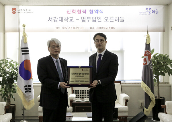 김순기(왼쪽) 서강대 대외부총장과 법무법인 오른하늘 이종민 대표 변호사가 업무협약식에서 협약 증서인  산학협력기관 현판을 들어보이고 있다. 사진=서강대 제공