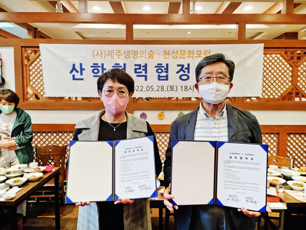 천성문화포럼과 제주생명의숲이 체결한 업무협약식에서 참석자들이 협약서를 펼쳐보이고 있다. 사진=영산대 제공