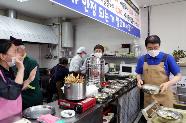 송승호(오른쪽) 충북보건과학대 봉사단장과 학생들이 '담쟁이의 국수이야기'에서 봉사활동을 하고 있다. 사진=충북보건과학대 제공