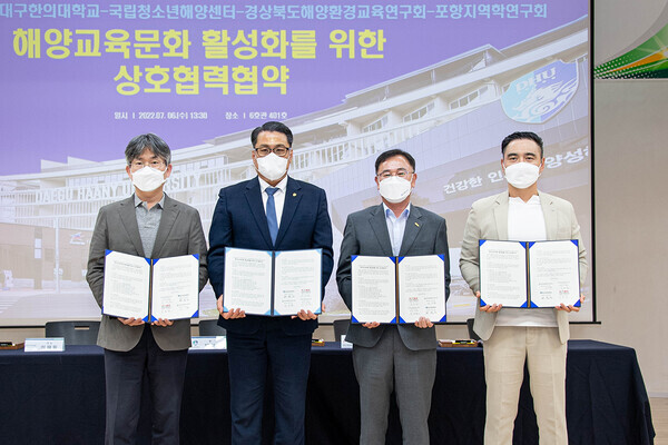 대구한의대의 해양교육문화 활성화를 위한 상호협력 협약식에서 협약 기관 관계자들이 협약서를 펼쳐보이고 있다. 사진=대구한의대 제공 